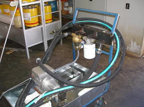 A filtration trolley in a workshop carrying a Magnom Clear unit and a spin-on filter