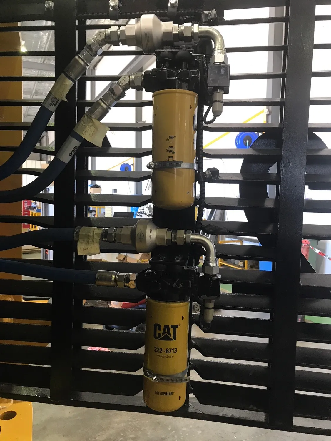 Two stainless in-line Magnom units plumbed in above a pair of Caterpillar filters
