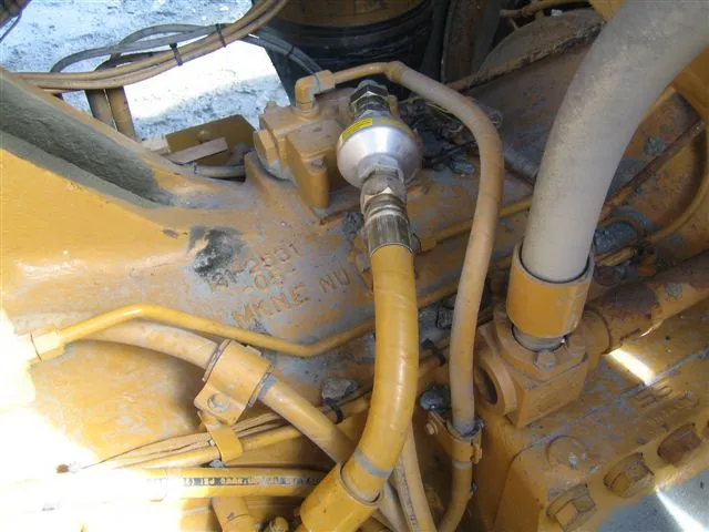 A Magnom unit fitted in an oil line on a yellow mining machine